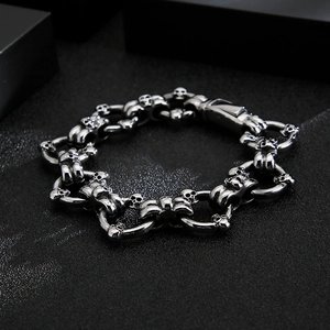 Detail of vintage punk skull chain bracelet in polished steel with antique finish