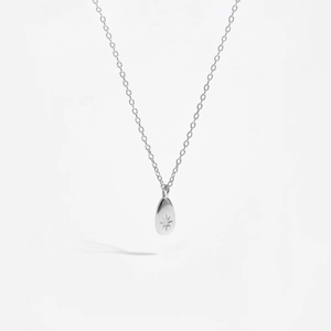 Detail of S925 sterling silver pear-shaped pendant with starburst engraving and thin chain