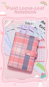 Detail view of A6 loose-leaf budget binder with colorful plaid inner pages and refillable binder