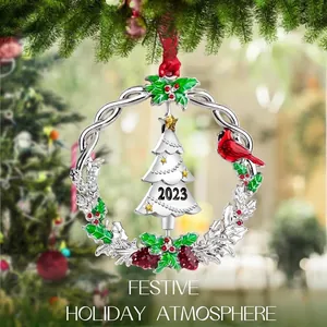2023 commemorative metal wreath ornament with red cardinal and silver tree in festive setting