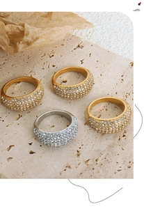 Detailed macro view of gold and silver dome rings with pavé set cubic zirconia stones