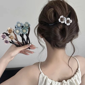Close-up of elegant floral twist hair clips in blue, purple, and orange colors