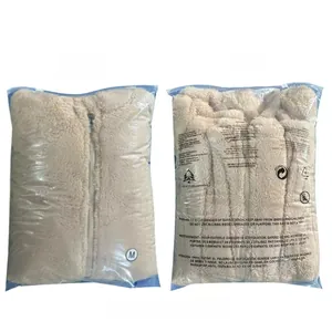 Front and back view of beige fleece jacket packed in transparent protective zipper bag