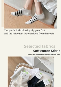 Close-up of soft cotton socks with dog embroidery and stripe patterns on a metal tray
