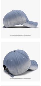 Macro view of blue distressed denim baseball cap with gradient wash and ripped details