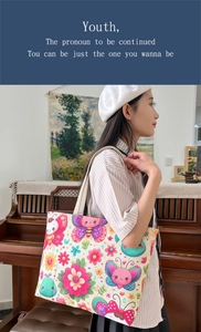 Detailed view of the colorful butterfly and floral prints on the canvas tote bag fabric