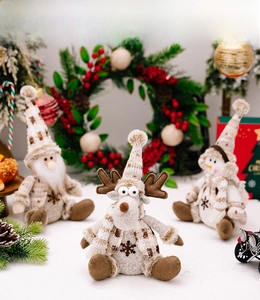Detail of Christmas plush figurines with knitted texture featuring Santa, Reindeer, and Snowman