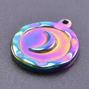 Macro shot of stainless steel round moon charm with rainbow iridescent finish for jewelry