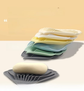 Macro detail of shell-shaped silicone soap dish with non-slip wave texture and drainage slots