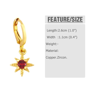Detail view of a gold starburst earring featuring a bright red zircon inlay and claw setting