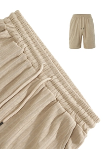 Macro view of khaki corduroy fabric detail on men's shorts with drawstring waist