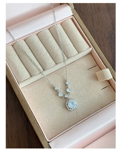 Detailed view of S925 silver necklace with square zircon pendant in a beige jewelry box