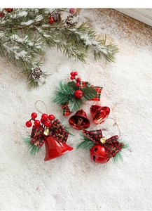 Close-up of red Christmas bells with bows and Merry Christmas print on snowy background