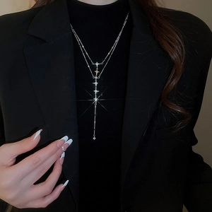 Close-up of double-layer stainless steel star necklace with sparkling zircon tassels