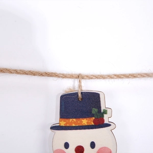 Close-up of wooden snowman ornament with blue star hat and natural jute twine hanging rope