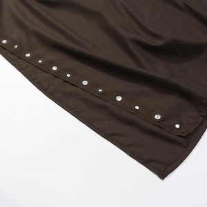 Brown fashion cape top featuring textured fabric and white button detail on a white background