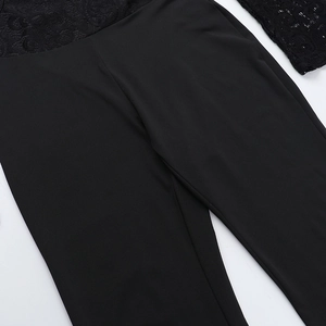 Detailed close-up showing the elegant lace and stretchy fabric stitching on this black jumpsuit