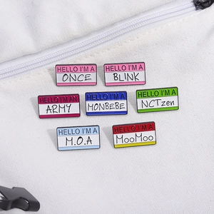 Set of colorful rectangular enamel pins featuring K-pop fan names on a canvas bag