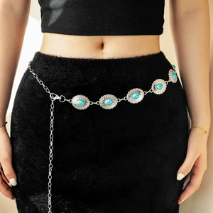 Close-up of bohemian silver waist chain featuring vintage turquoise floral metal links