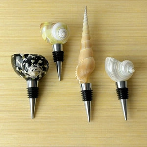 Set of four seashell and conch wine bottle stoppers with stainless steel seal