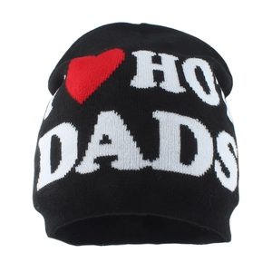 Detail of black knit beanie featuring white letters and red heart jacquard embroidery