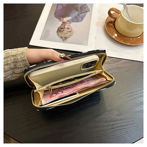 Internal view of the black cross-pattern wallet showing large capacity for phone and cards