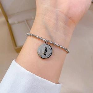 Silver bead chain bracelet with vintage coin pendant featuring an Elizabeth II portrait