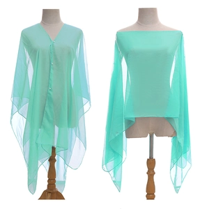 Close-up of light green sheer shawl with pearl buttons showing multiple wearing styles