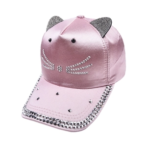Detailed view of pink satin baseball cap with rhinestone cat ears and face embroidery