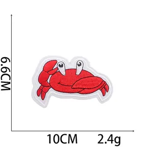 Detail of red cartoon crab embroidered patch with size markings 10cm by 6.6cm