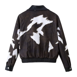 Back view of short cow print jacket with brown spots and black faux leather collar