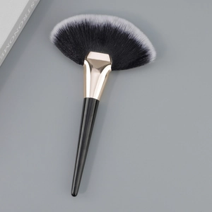 Large fan-shaped highlighter brush with gradient bristles and sleek black tapered handle