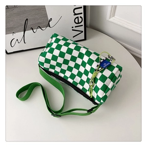 Detail of green and white checkerboard canvas Boston bag with adjustable strap