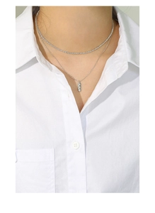 Detail of layered S925 sterling silver necklaces with zircon bar and tennis chain style