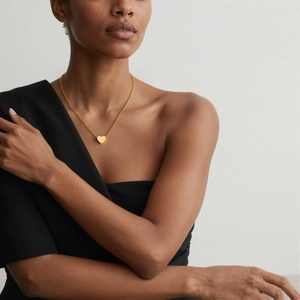 Minimalist 18k gold plated heart pendant necklace on model with polished finish