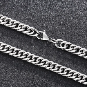 Macro detail of silver stainless steel Cuban link chain with secure lobster clasp closure