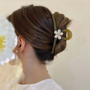 Elegant large green resin flower hair claw clip shown on model for stylish updos