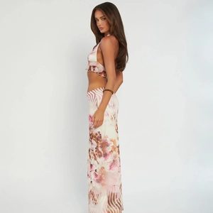 Detail of floral print halter top and long skirt in pink and ivory breathable chiffon