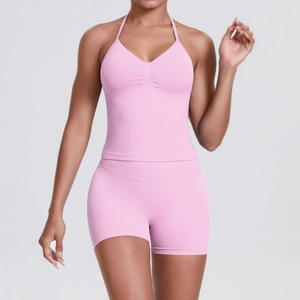 Close-up of pink seamless yoga set showing breathable knit texture and halter neckline