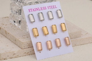 Macro shot of 6 pairs of polished stainless steel stud earrings in silver, gold, and rose gold