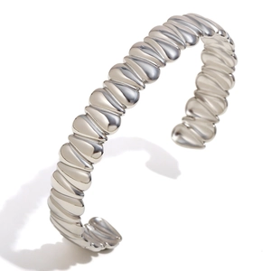 Modern minimalist silver wave ripple cuff bracelet with a thick chunky teardrop design