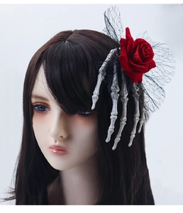 Gothic Halloween hair clip with red rose, skeletal hand and black lace on model