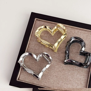Elegant hollow heart-shaped metal hair claws in gold, silver, and gunmetal finishes