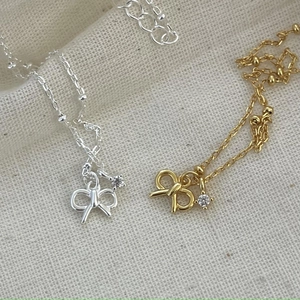 Elegant 925 sterling silver bow necklace with zircon in gold and silver finishes