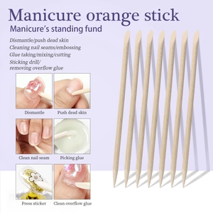 Detailed view of dual-tipped orange wood nail sticks for cuticle repair and nail art