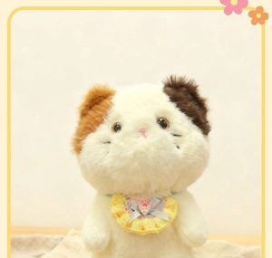 Detailed texture of yellow handmade lace pet collar with bow on white plush stuffed cat