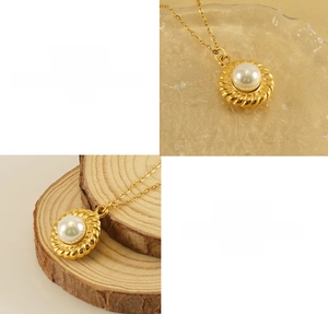 Detail of 18k gold sunflower pendant in titanium steel with a center pearl inlay