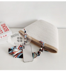 Detailed shot of woven tote bag featuring silk scarf handle and wooden beads accent