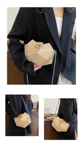Detail of beige geometric textured handbag featuring a stylish silver chain shoulder strap