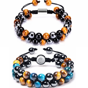 Detail of woven double-row bead bracelets with tiger eye stones and Om symbol charm